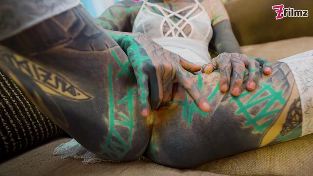 Heavily tattooed solo girl in lingerie masturbates rigid with massive dildo